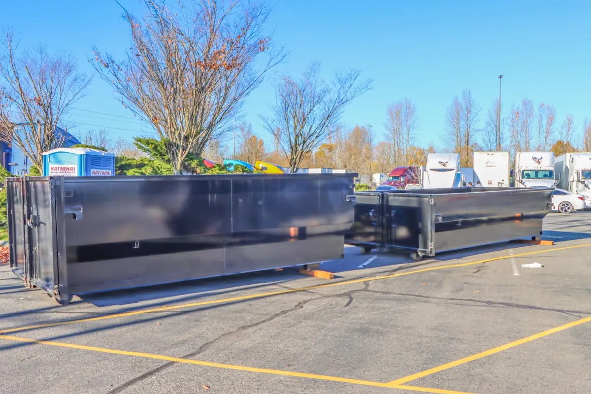Professional dumpster rental service with roll-off container on residential driveway in Lower Providence